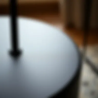 Close-up of a round black end table showcasing material texture