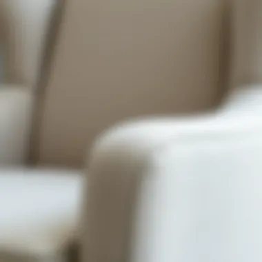 Close-up view of the texture and fabric of a light grey wingback chair