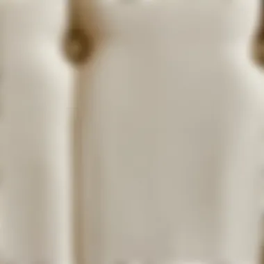 Close-up of the fabric texture on a beige upholstered queen bed frame.