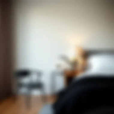 Cozy corner featuring a small black chair and a bedside table