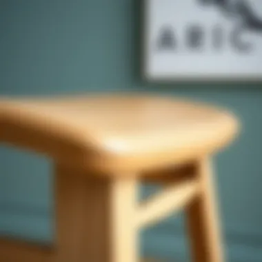 A close-up of the natural wood grain on an unfinished counter height chair